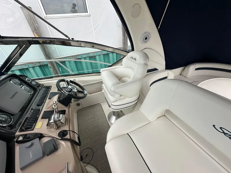 Slide: The Image of Interior of 2003 Sea Ray 420 Sundancer yacht with helm and seating area. - 21