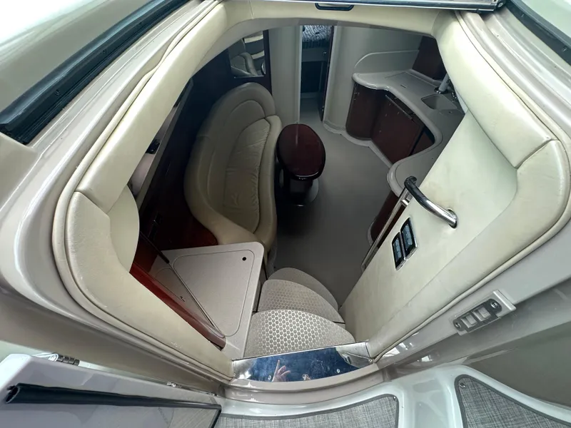 Slide: The Image of Interior view of 2003 Sea Ray 420 Sundancer yacht, featuring elegant seating and cabinetry. - 30