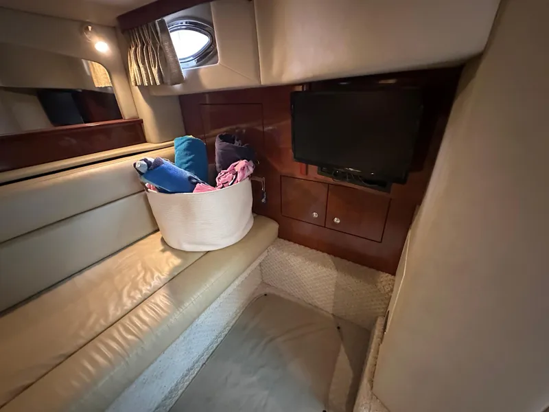Slide: The Image of 2003 Sea Ray 420 Sundancer cabin interior with TV and seating area. - 35