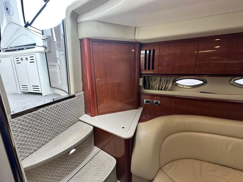 Slide: The Image of Interior of 2003 Sea Ray 420 Sundancer yacht with elegant wood cabinetry and plush seating. - 38