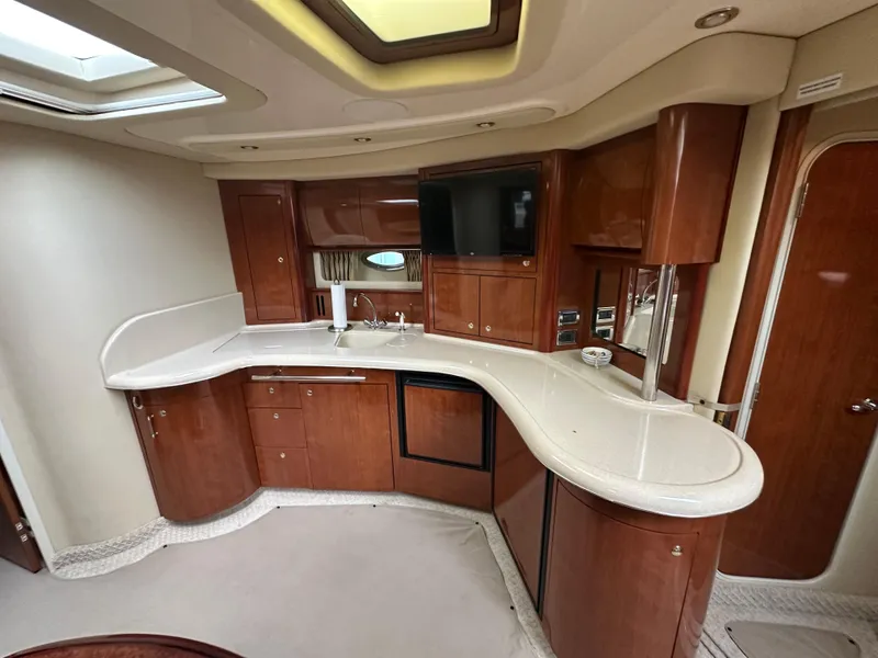 Slide: The Image of Luxurious interior of 2003 Sea Ray 420 Sundancer yacht with elegant wood cabinetry and modern amenities. - 43