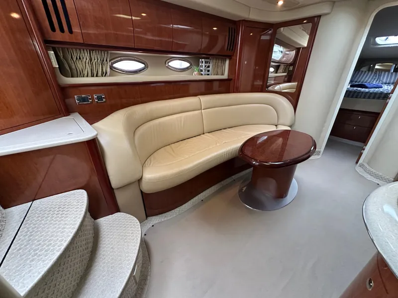 Slide: The Image of Luxurious interior of 2003 Sea Ray 420 Sundancer yacht with leather seating and wooden accents. - 44