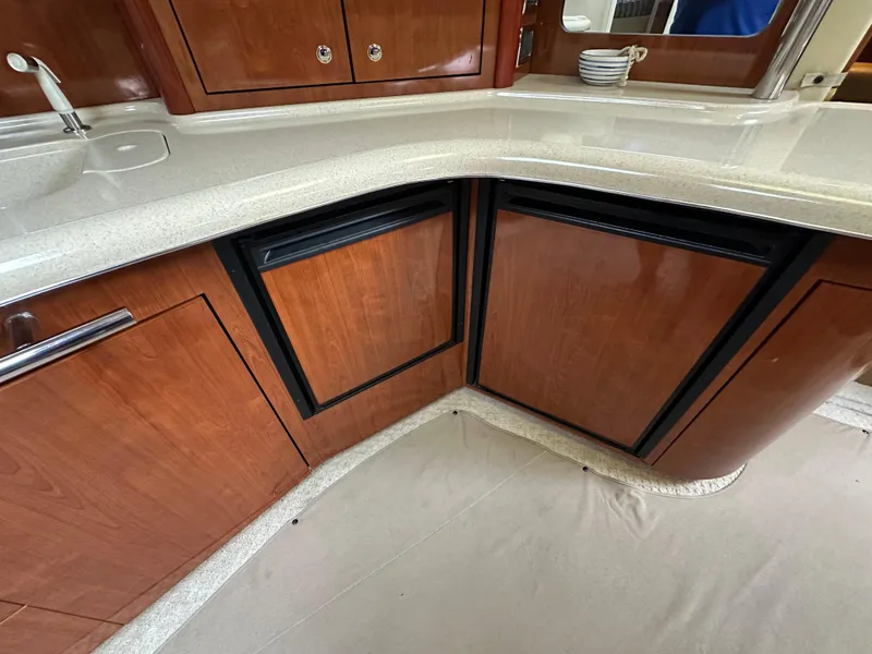 Slide: The Image of 2003 Sea Ray 420 Sundancer kitchen with wooden cabinets and countertop. - 45