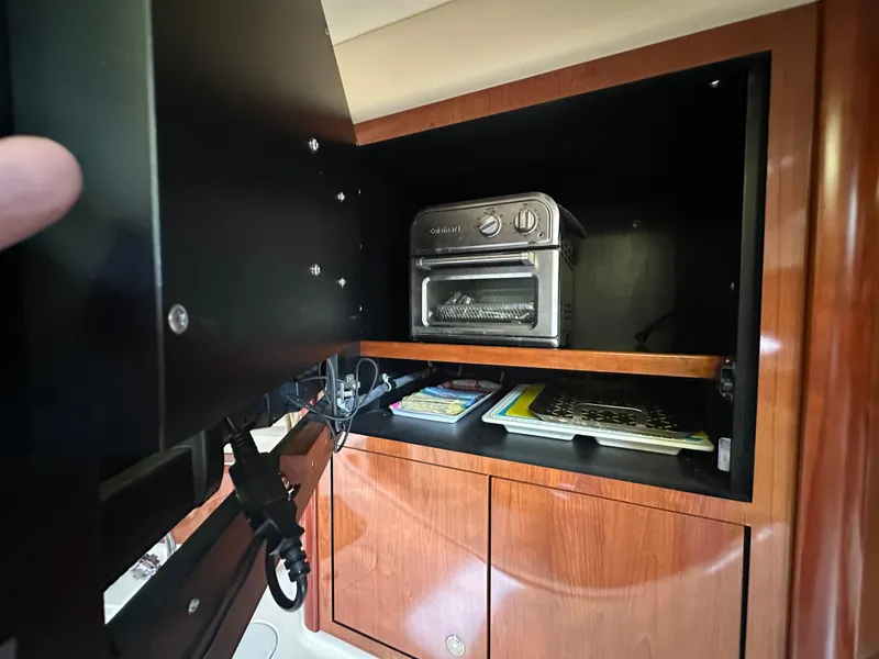 Slide: The Image of Cabinet interior on 2003 Sea Ray 420 Sundancer with toaster oven and storage. - 50
