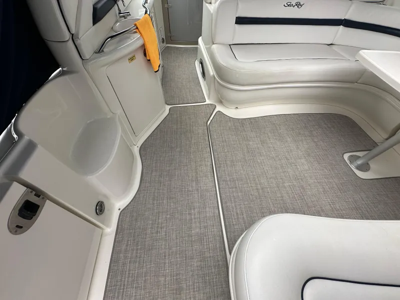 Slide: The Image of 2003 Sea Ray 420 Sundancer interior with white seating and gray flooring. - 8