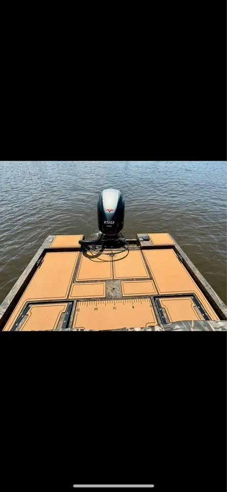 Slide: The Image of 2023 G3 Bay 20 GX boat with motor on calm water. - 11