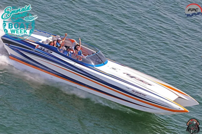 The Image of 2010 Daves Custom Boats M35 with vibrant orange and blue accents on display. - 0