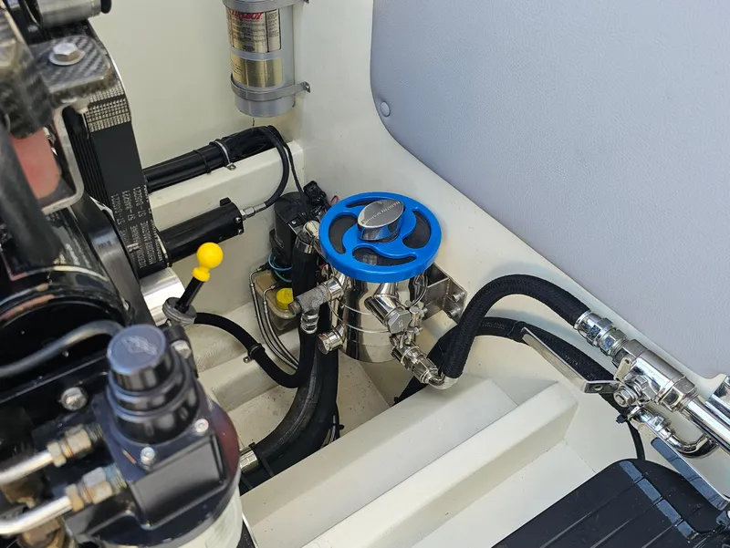 Slide: The Image of 2010 Daves Custom Boats M35 with vibrant stripes, parked near other boats and vehicles. - 10