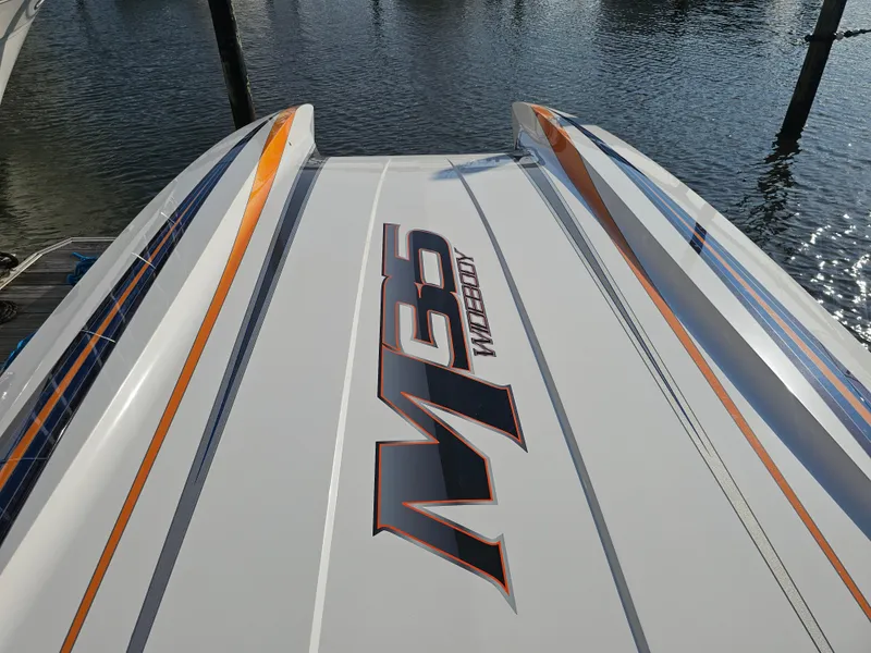 Slide: The Image of 2010 Daves Custom Boats M35 with vibrant blue and orange detailing. - 17