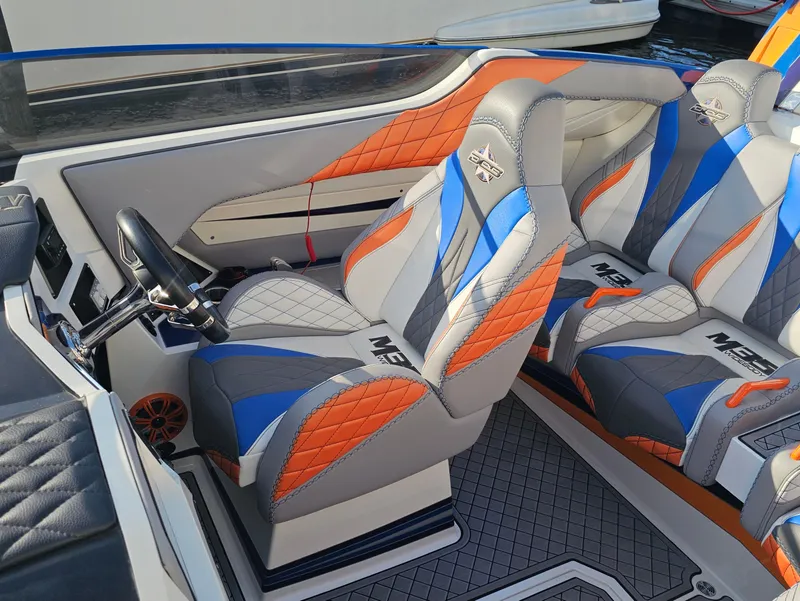 Slide: The Image of 2010 Daves Custom Boats M35 interior with vibrant blue, orange, and gray seating. - 29