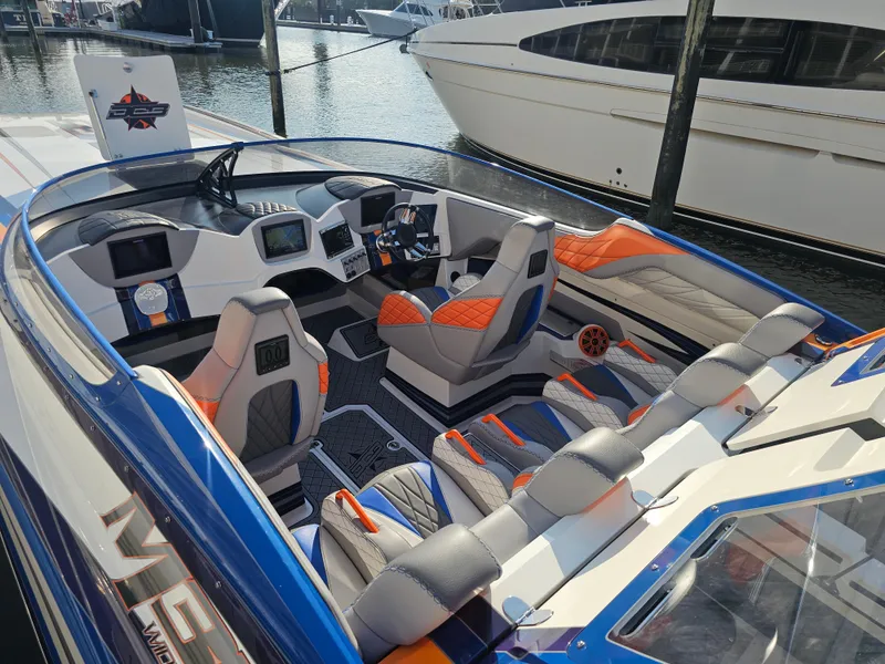 Slide: The Image of 2010 Daves Custom Boats M35 with vibrant blue and orange design on display. - 3