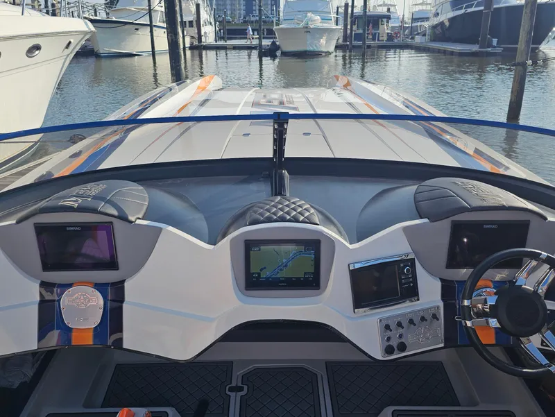Slide: The Image of Interior of 2010 Daves Custom Boats M35 with vibrant orange, blue, and gray seating. - 35