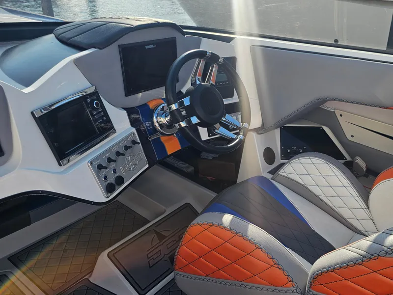 Slide: The Image of 2010 Daves Custom Boats M35 interior with blue, gray, and orange seats. - 37