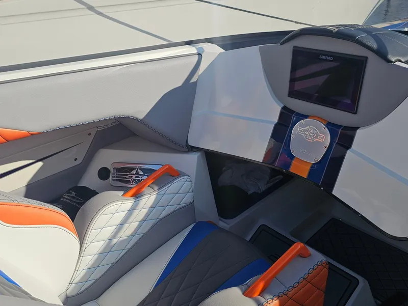 Slide: The Image of Interior of 2010 Daves Custom Boats M35 with vibrant blue and orange seating design. - 38