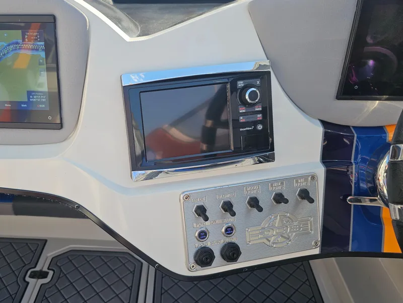 Slide: The Image of Dashboard of a 2010 Daves Custom Boats M35 with steering wheel and navigation controls. - 41