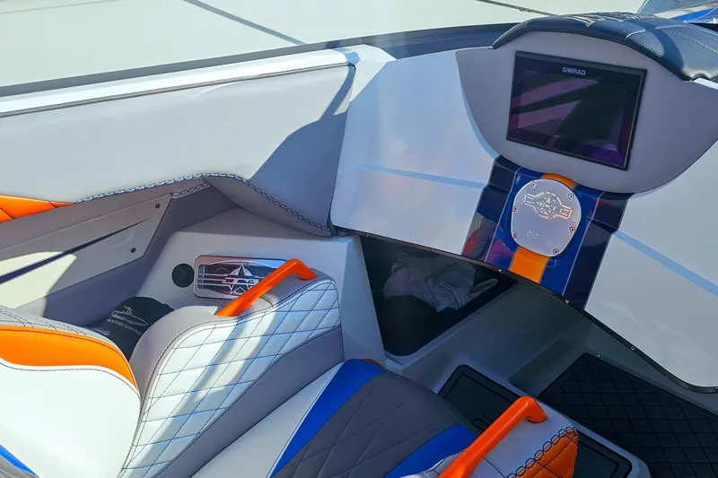Slide: The Image of Interior of 2010 Daves Custom Boats M35 with vibrant seating and dashboard display. - 45