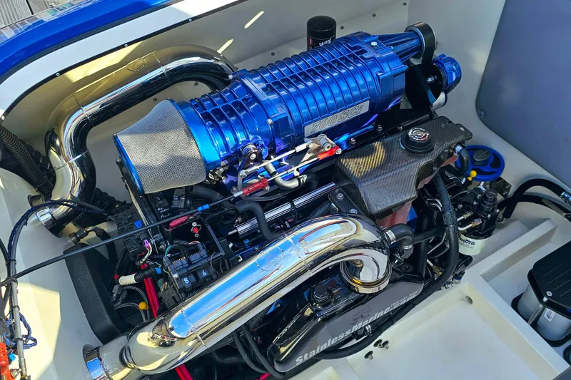 Slide: The Image of High-performance engine of a 2010 Daves Custom Boats M35, featuring a blue supercharger. - 47