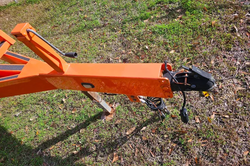Slide: The Image of Orange trailer hitch of 2010 Daves Custom Boats M35 on grassy ground. - 58