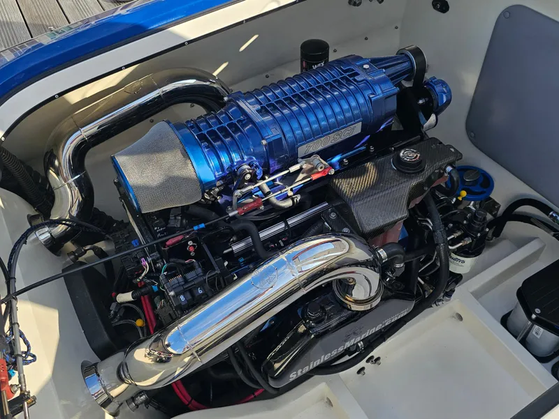 Slide: The Image of 2010 Daves Custom Boats M35 on trailer, sleek design with orange accents, dockside view. - 6