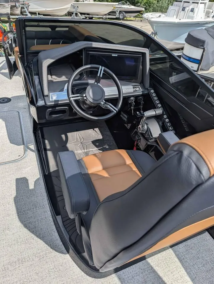 Slide: The Image of 2025 Berkshire 25 Sport RFX9-DC boat interior with modern steering and controls. - 16