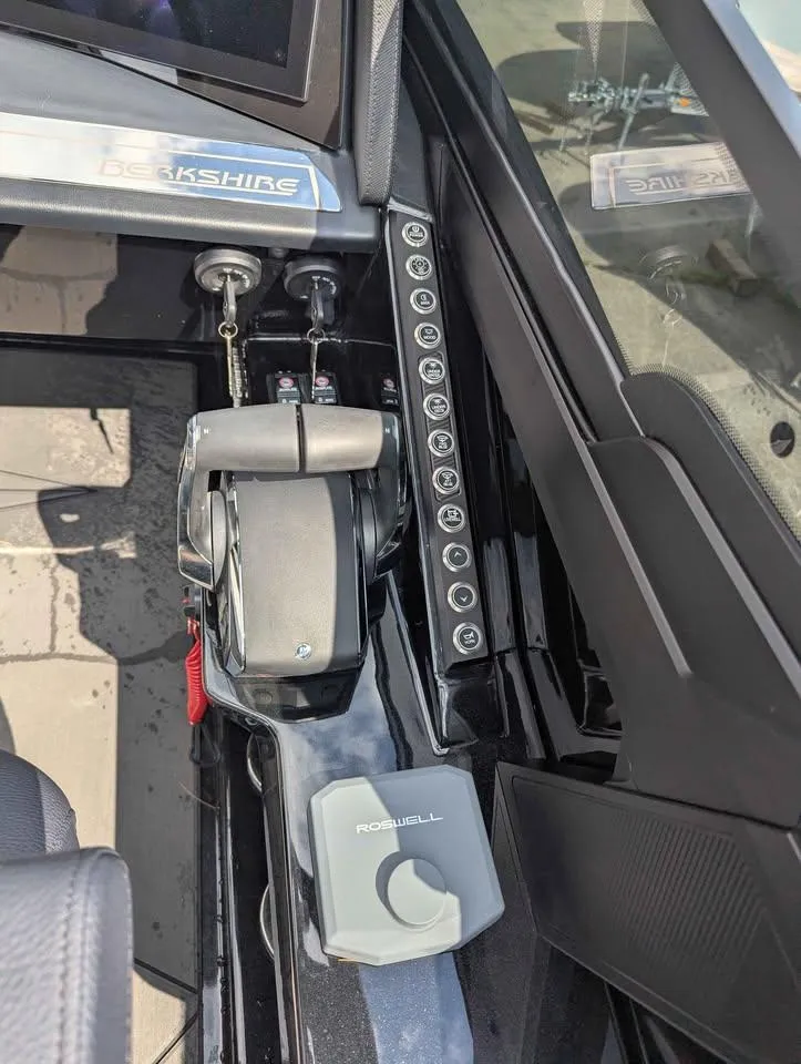 Slide: The Image of Control panel of 2025 Berkshire 25 Sport RFX9-DC boat with throttle and switches. - 18