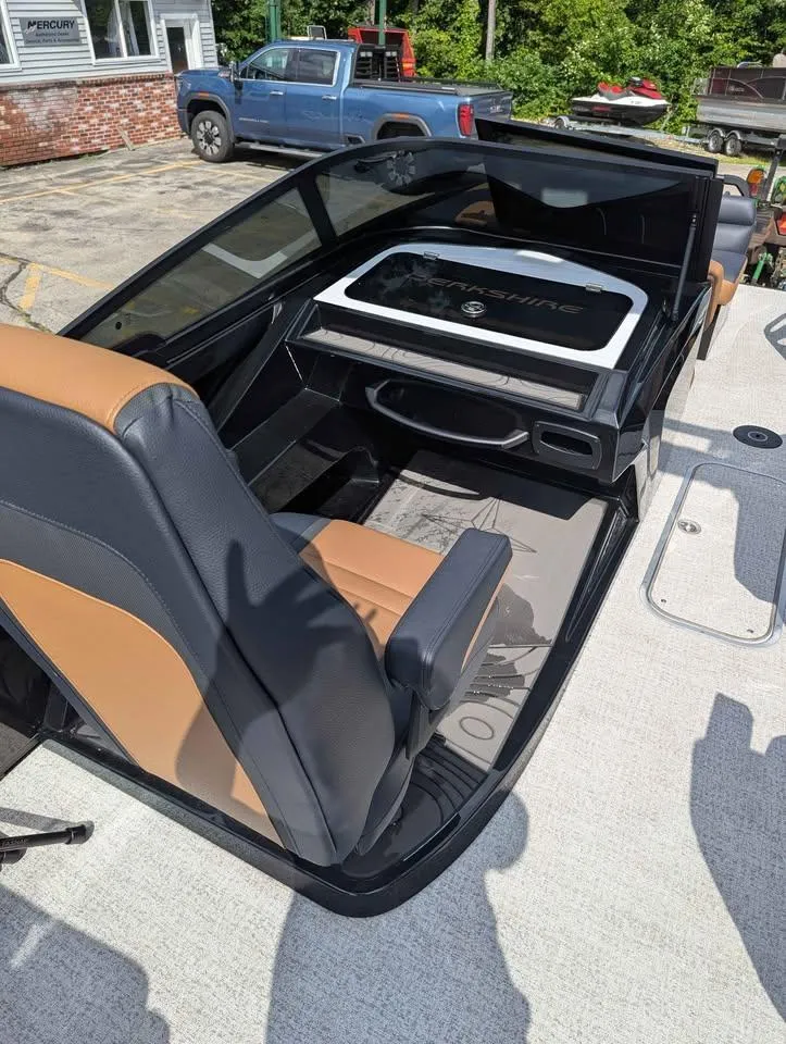 Slide: The Image of 2025 Berkshire 25 Sport RFX9-DC boat interior with tan and black seating. - 19