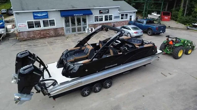 Slide: The Image of 2025 Berkshire 25 Sport RFX9-DC pontoon boat on trailer, parked outside dealership. - 3