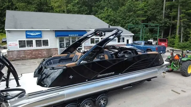 Slide: The Image of 2025 Berkshire 25 Sport RFX9-DC pontoon boat parked outside a dealership. - 4