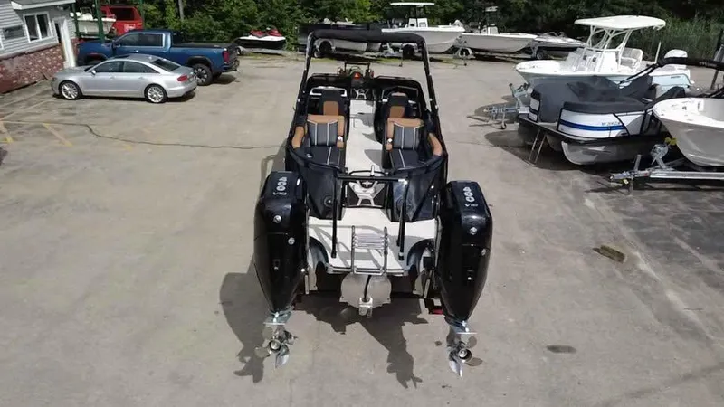 Slide: The Image of 2025 Berkshire 25 Sport RFX9-DC boat with dual engines in a marina parking lot. - 5