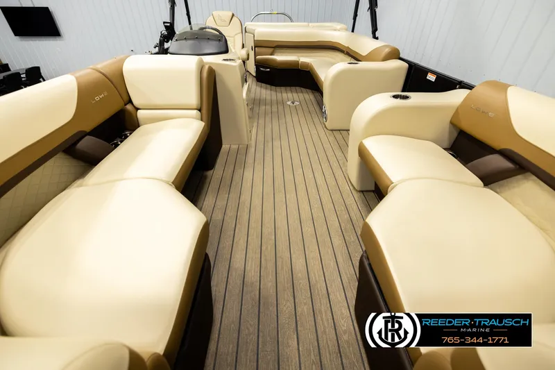 Slide: The Image of 2023 Lowe 210 SSTL boat interior with beige and brown seating, wood-style flooring. - 13