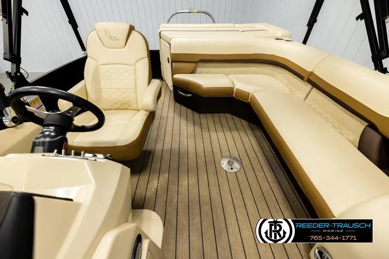 Slide: The Image of 2023 Lowe 210 SSTL boat interior with beige seating and wood flooring. - 14