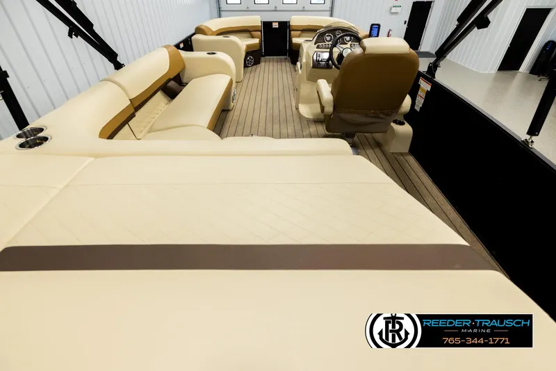 Slide: The Image of 2023 Lowe 210 SSTL boat interior with beige seating and wood flooring. - 16