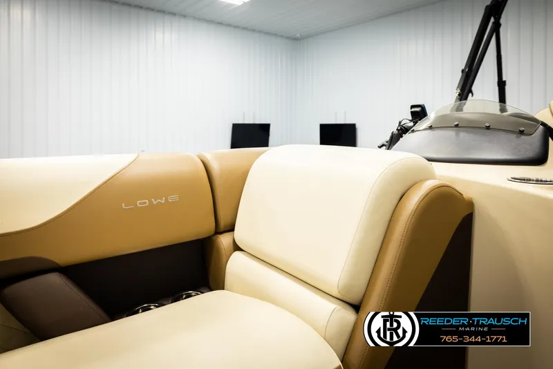 Slide: The Image of 2023 Lowe 210 SSTL boat interior with beige seating in showroom. - 20