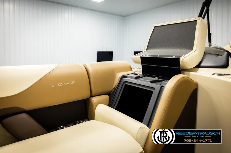 Slide: The Image of 2023 Lowe 210 SSTL boat interior with tan seating and console, Reeder-Trausch Marine logo. - 21