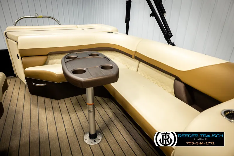 Slide: The Image of 2023 Lowe 210 SSTL boat interior with beige seating and cupholder table. - 23