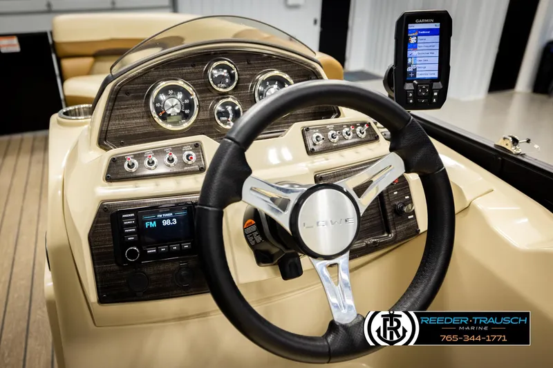 Slide: The Image of Steering console of 2023 Lowe 210 SSTL boat with gauges and Garmin device. - 28