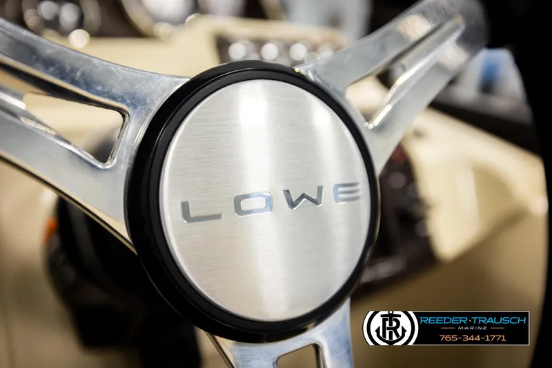 Slide: The Image of Steering wheel of 2023 Lowe 210 SSTL boat, featuring sleek metallic design. - 29