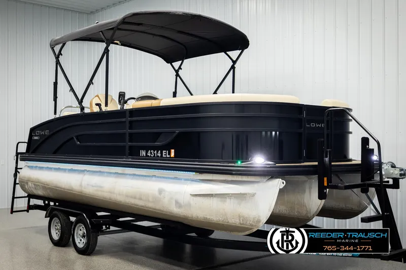 Slide: The Image of 2023 Lowe 210 SSTL pontoon boat on trailer in indoor showroom. - 3