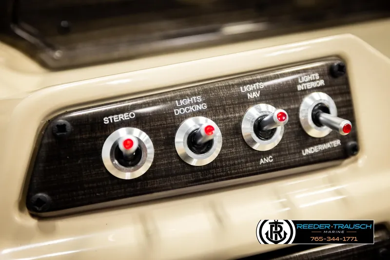 Slide: The Image of Control panel of 2023 Lowe 210 SSTL boat with labeled switches for lights and stereo. - 31