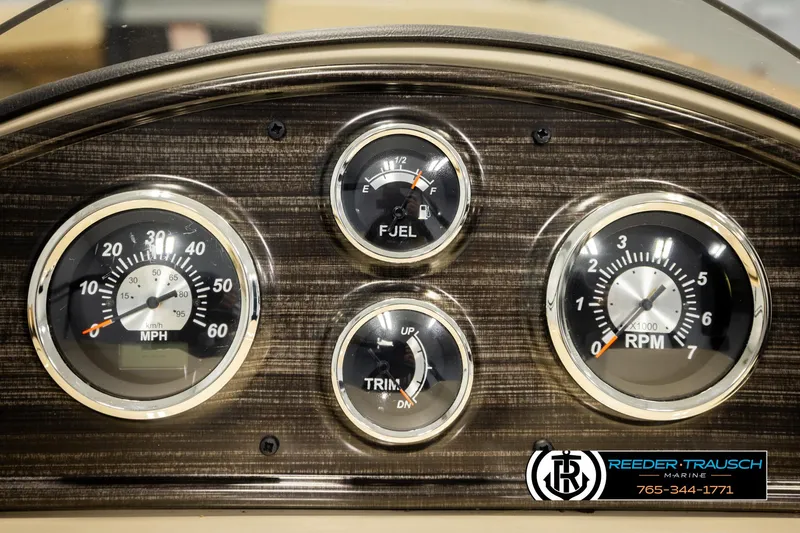 Slide: The Image of Dashboard of 2023 Lowe 210 SSTL boat with speedometer, fuel, trim, and RPM gauges. - 32
