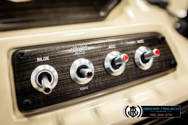 Slide: The Image of Control panel of 2023 Lowe 210 SSTL boat with switches for bilge, aerator, and accessories. - 33