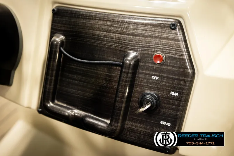 Slide: The Image of Control panel of 2023 Lowe 210 SSTL boat with ignition switch and red indicator light. - 34