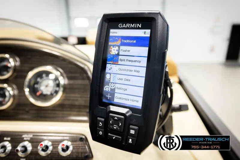 Slide: The Image of Garmin marine display on 2023 Lowe 210 SSTL boat dashboard, featuring navigation options. - 35
