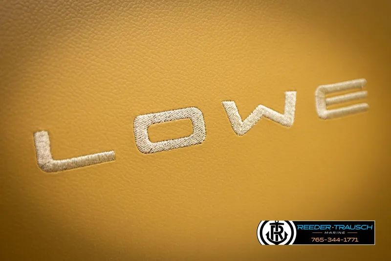 Slide: The Image of Close-up of 2023 Lowe 210 SSTL logo on tan leather surface. - 40