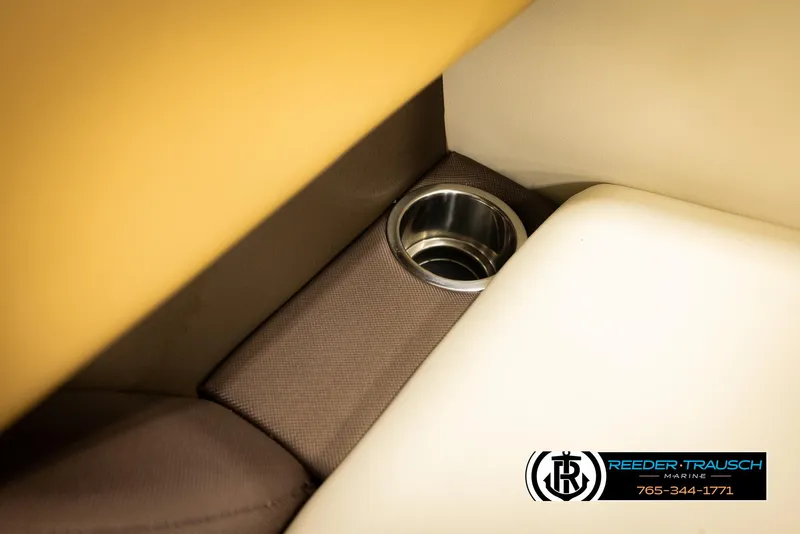 Slide: The Image of Cup holder in 2023 Lowe 210 SSTL boat interior, featuring beige and brown upholstery. - 41