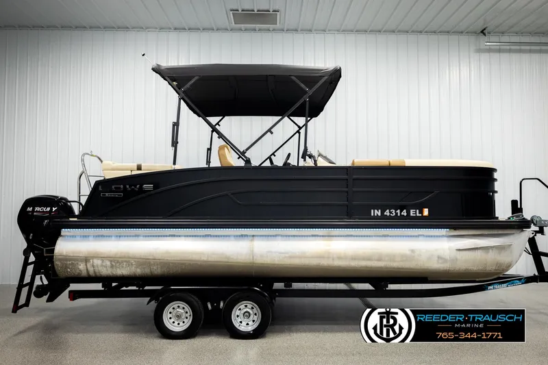 Slide: The Image of 2023 Lowe 210 SSTL pontoon boat on trailer in indoor showroom. - 5