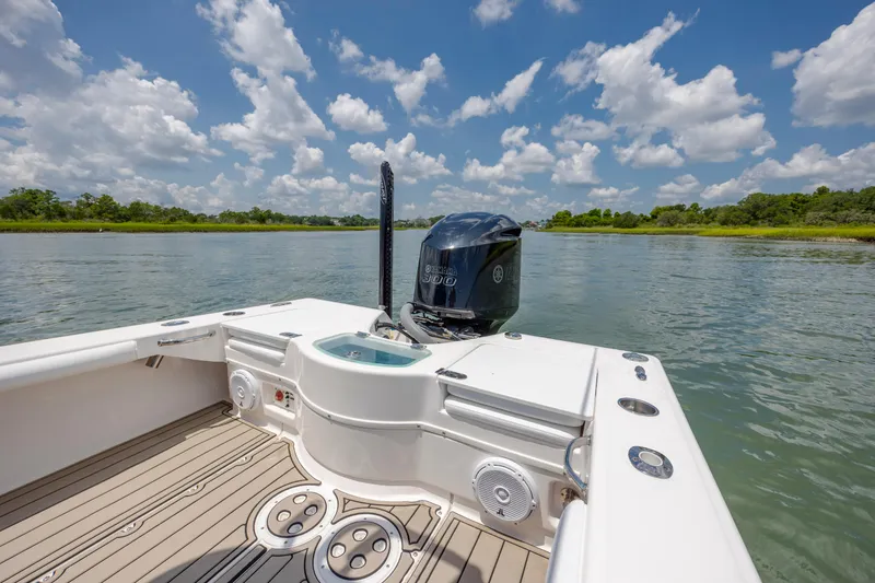 Slide: The Image of 2015 Everglades 243 Center Console boat on calm water under a blue sky. - 10