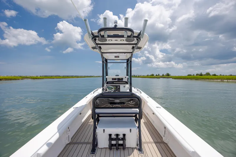 Slide: The Image of 2015 Everglades 243 Center Console boat on calm water under a partly cloudy sky. - 11
