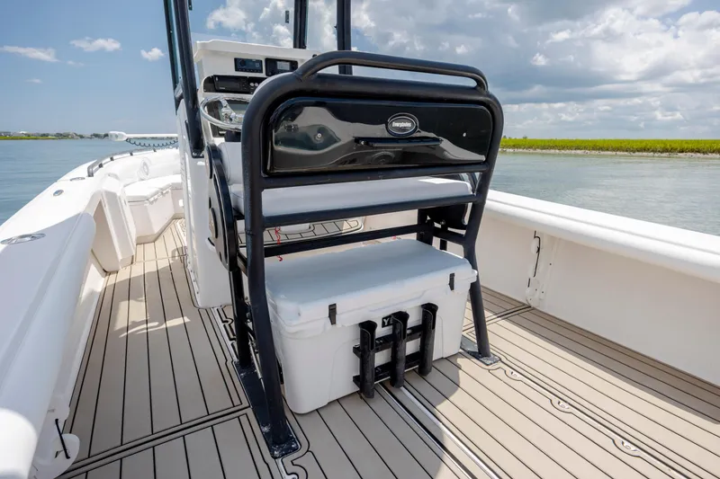 Slide: The Image of 2015 Everglades 243 Center Console boat interior with cooler and steering console. - 12