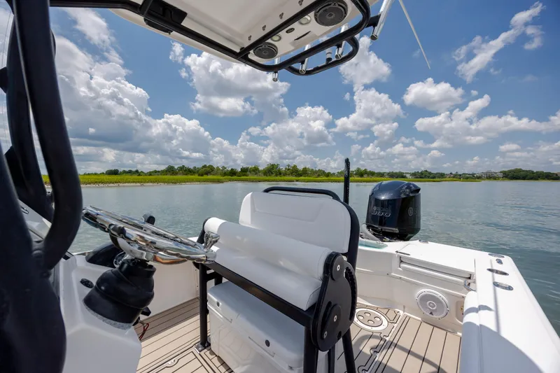 Slide: The Image of 2015 Everglades 243 Center Console boat on calm water under a blue sky. - 13